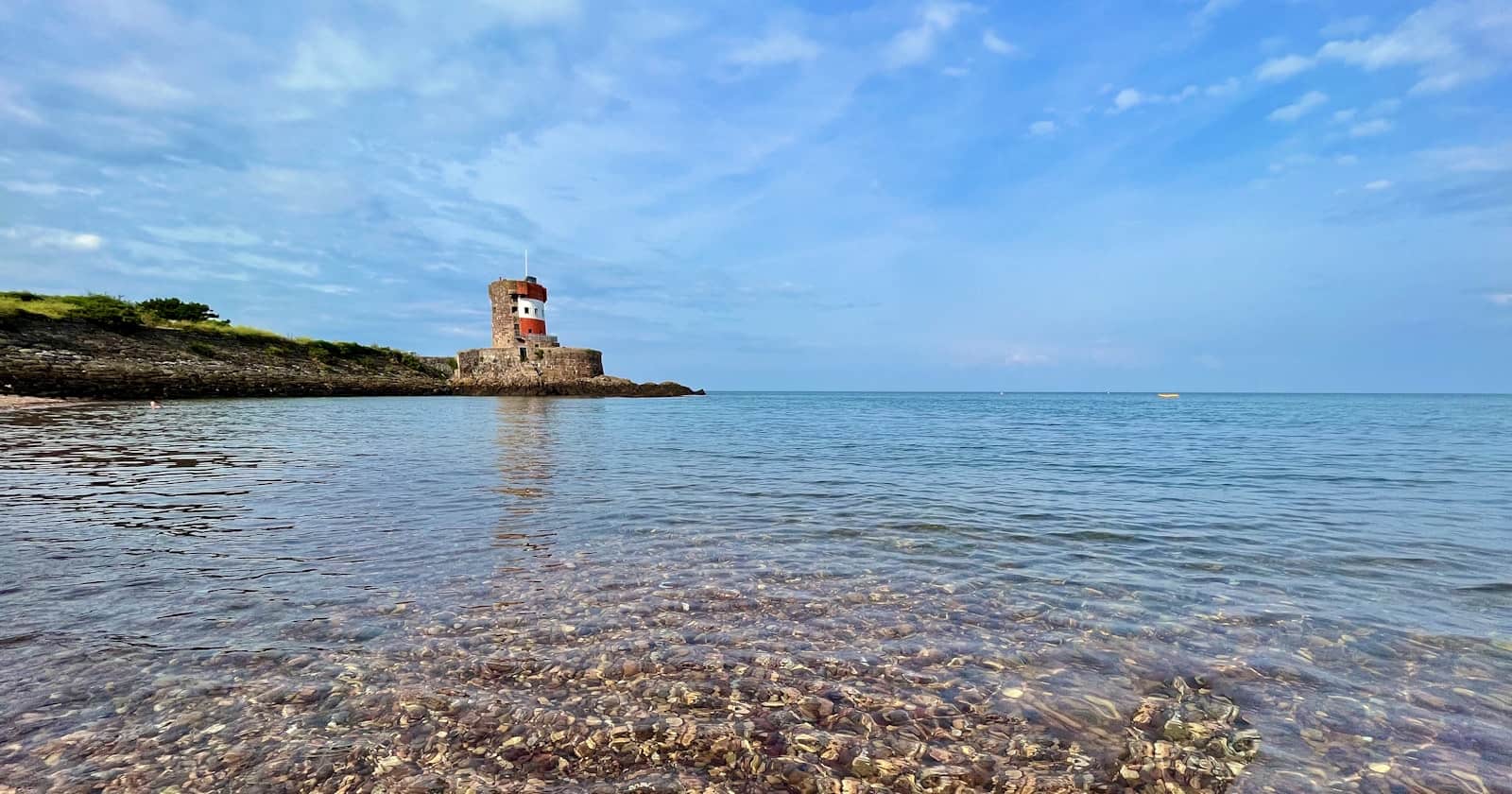 Archirondel Tower over clear turquoise water, Jersey, Channel Islands
