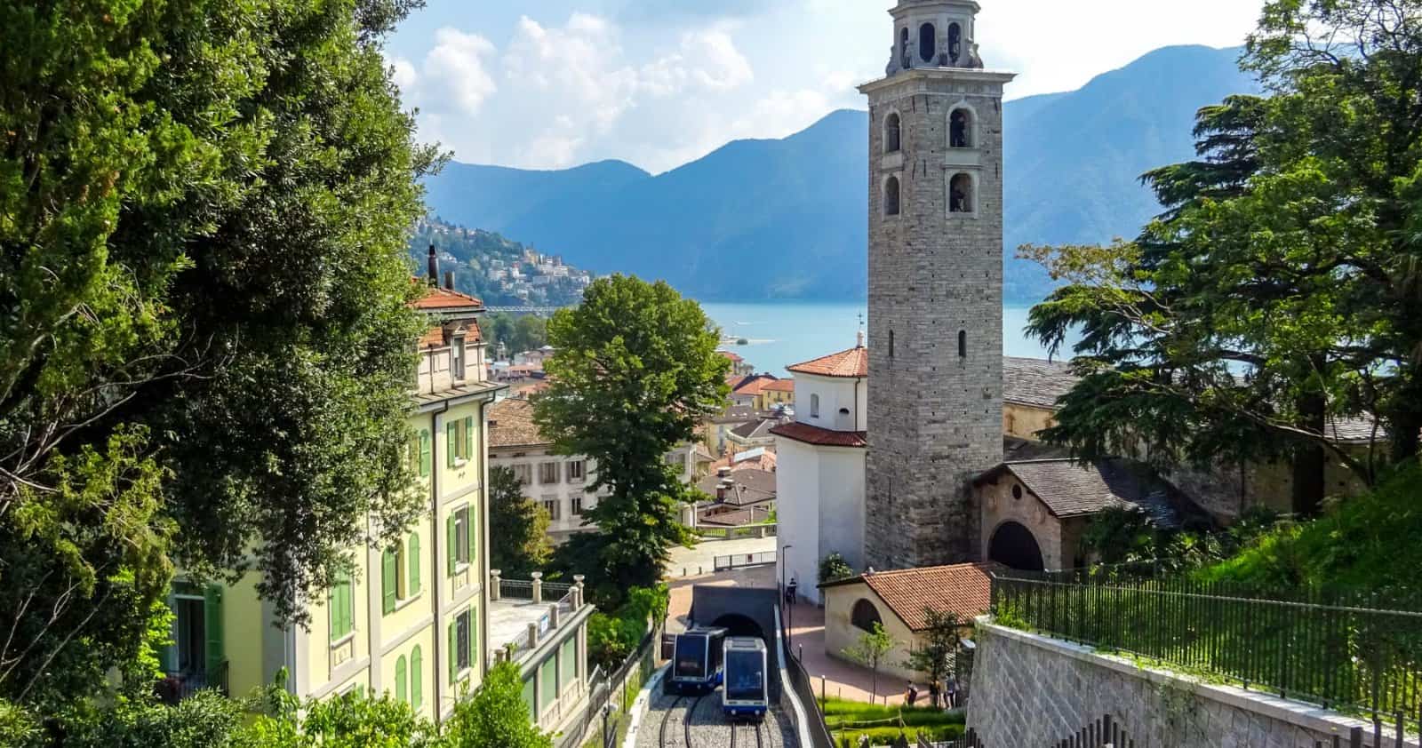Lugano, Ticino: the San Lorenzo cathedral bell tower above the funicular running down to Lake Lugano