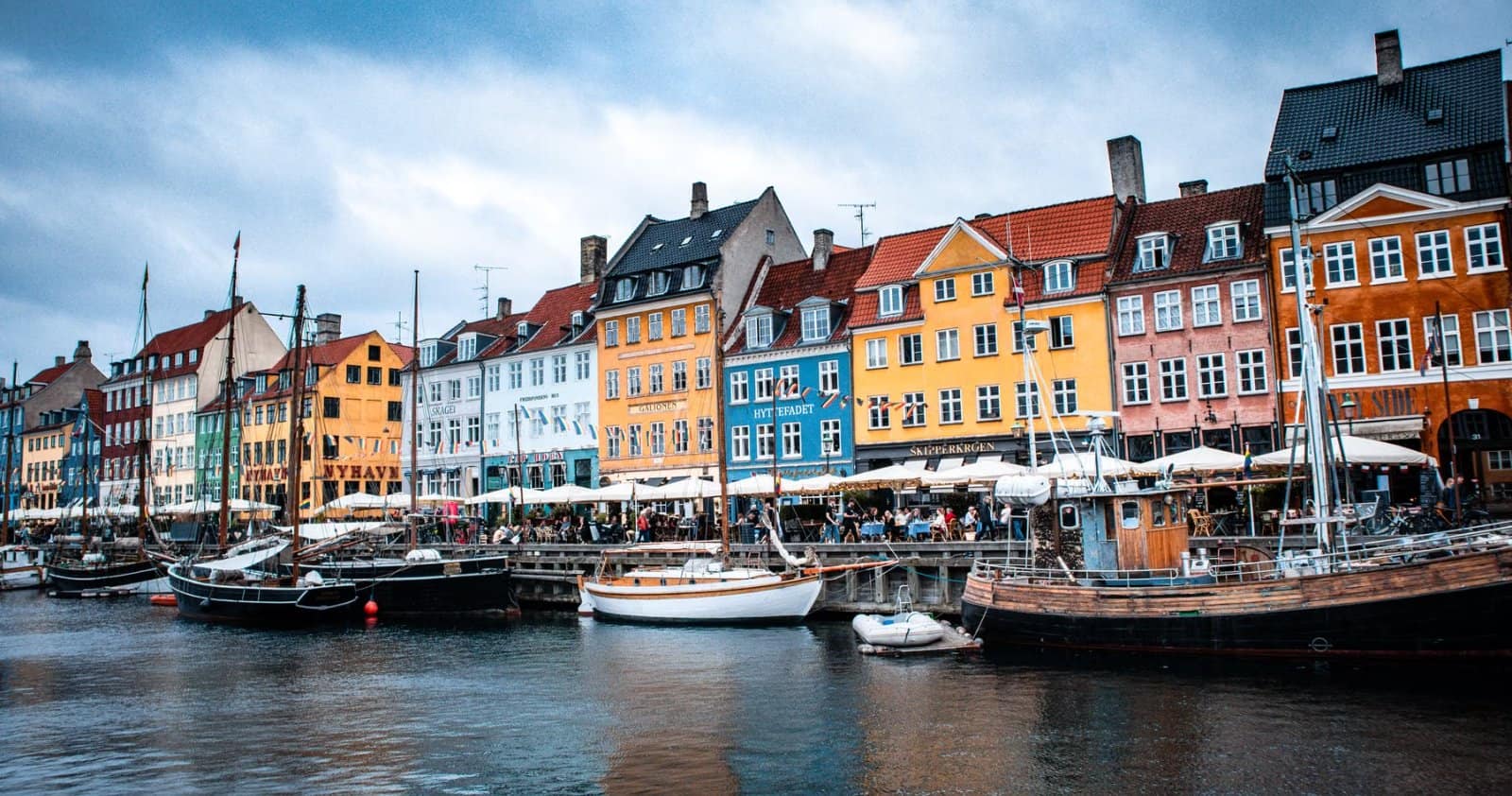 Nyhavn canal in Copenhagen, Denmark, with colourful historic facades and moored boats
